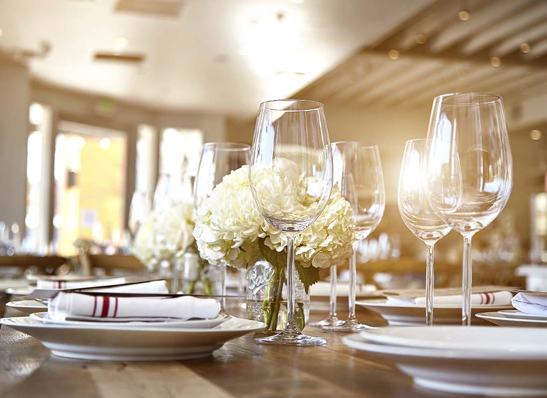 Special Event Insurance - Close-up of a Tasteful Table Set Display of Wine Glasses and Flowers for an Large Event or Celebration